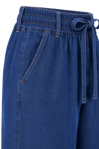 Blue denim pants with drawstring waistband on a white background